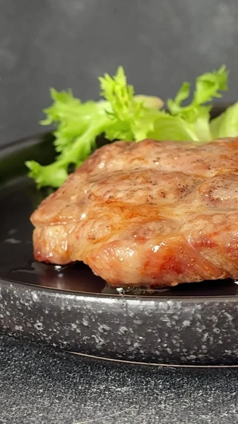 Pork steak roasted meat grilled barbecue main course lunch or dinner tasty food Stock Footage 335655131