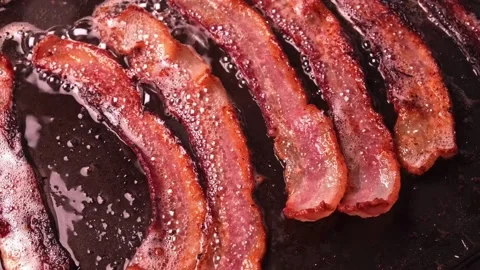 Pork stripes being prepared for breakfast at home kitchen. 스톡 동영상 334641751