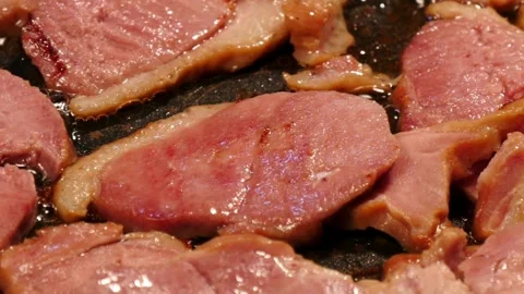 Pork stripes being prepared for breakfast at home kitchen. 스톡 동영상 334641865