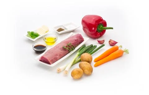 Pork tenderloin,  meat with various ingredients isolated on white background Stock Photos