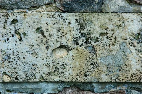 Porous weathered stone block wall texture close up Foto stock
