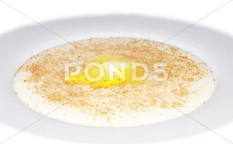 Porridge in a deep bowl with butter eye Stock Photos