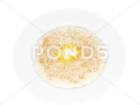Porridge in a deep bowl with butter eye Stock Photos