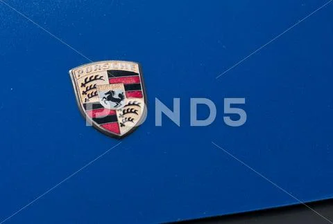 Porsche sign on the blue car hood Stock Photos