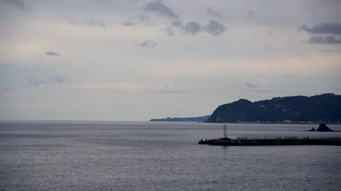 Port and lighthouse at dusk Stock Footage 260674291