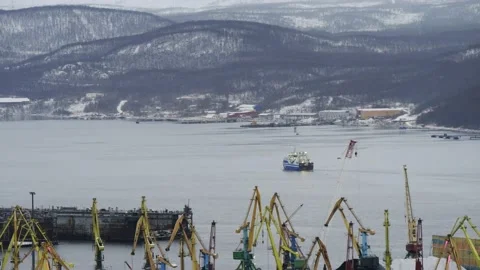 Port and working cranes on the background of the Bay and low mountains. Stock Footage 143215251