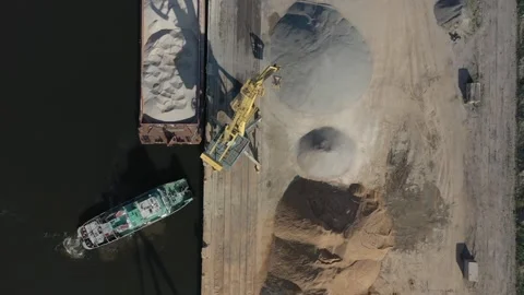 Port crane loading sand from barge. Aerial view. Stock Footage 169949957