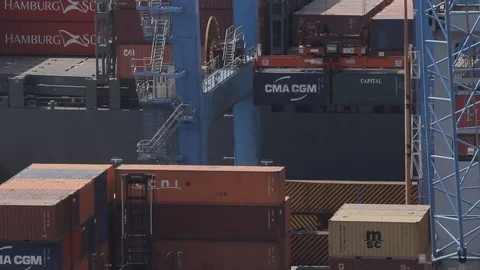 Port crane lowering containers Stock Footage 77052542