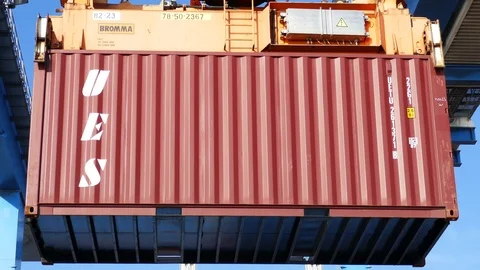 Port crane moves a cargo container 4k intro video for business Stock Footage 104502219