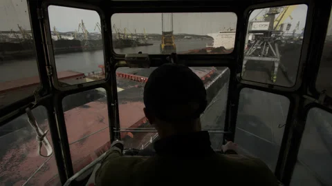 Port crane operator controls process of moving cargo. Operations with bulk coal Video stock 205229286