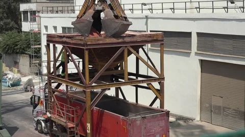 Port crane with scoop loading ship with artificial fertilizer Stock-Footage 248963287