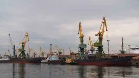 The port crane unloads the cargo ship at the pier Stock Footage 92206658