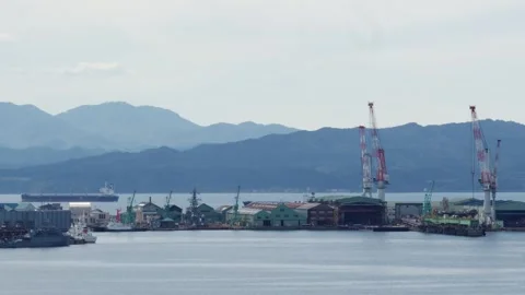 Port cranes and shipyard facility over blue water, Hakodate, Japan, 2026.09.10. 動画素材 345432014