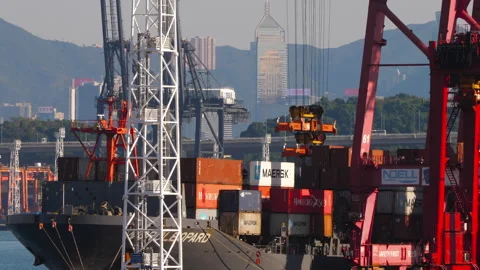 Port cranes loading cargo containers onto ship in Hong Kong Stock Footage 340920031