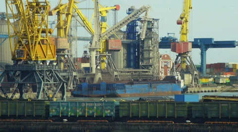 Port cranes loading cargo ship with cargo cars on a foreground Video stock 37428877