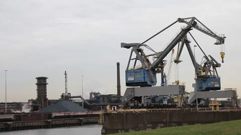 Port cranes loading dry-cargo ship at dusk Stock Footage 44816872