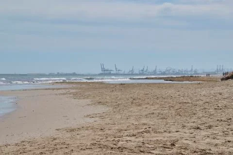 The port cranes seen from the beach Stock Photos