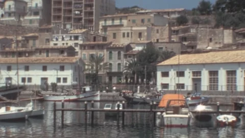 Port de Soller, Mallorca - 1977: Harbor with boats docking and waterfront houses Stock Footage 308714926
