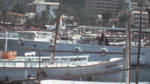 Port de Soller, Mallorca - 1977: Tourists embark on boats during summer holidays Stock Footage 308714962