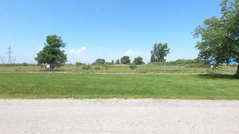 Port Dover, Can May 23 2026 POV side view driving plate farms and trees country Stock Footage 338301082