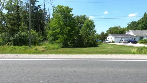 Port Dover, Can May 23 2026 POV side view driving plate farms and trees country Stock Footage 338304963