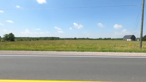 Port Dover, Can May 23 2026 POV side view driving plate farms and trees country Stock Footage 338305231