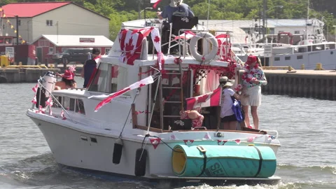 Port Dover, Canada July 1 2026 Canada day celebration with flag covered boats Stock Footage 338124832