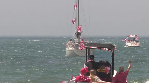 Port Dover, Canada July 1 2026 Canada day celebration with flag covered boats Stock Footage 338131337