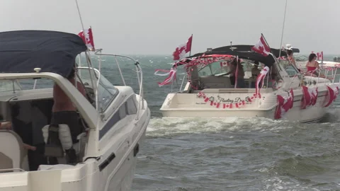 Port Dover, Canada July 1 2026 Canada day celebration with flag covered boats Stock Footage 338131472