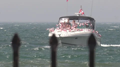Port Dover, Canada July 1 2026 Canada day celebration with flag covered boats Video stock 338133397