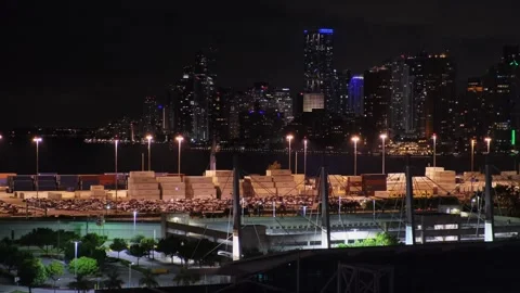 Port facilities of Miami, Florida. Docks with rows of stacked packaged goods lit Stock Footage 275559904