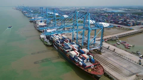 Port Klang with container ships loading cargo. Dramatic aerial view drone Stock Footage 344601773