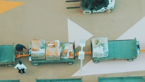 Port Logistics Workers Managing Wrapped Cargo Trailers from Above Video stock 346923593