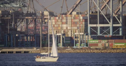 Port Of Long Beach Cargo Offloading Area With Sailboat Passing In Front Stock Footage 163308258