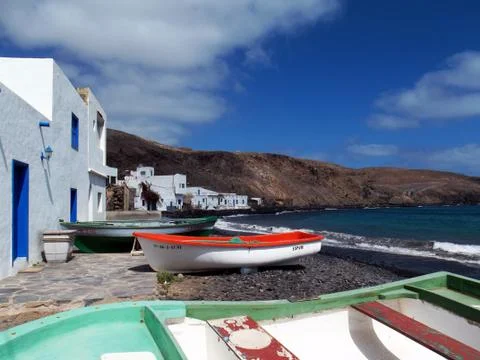 Port of pozo Negro, Fuerteventura, Spain, with colorful boats by the sea Stock Photos