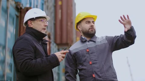 Port workers engineer hold a meeting before starting work at the commercial Stock Footage 306217516