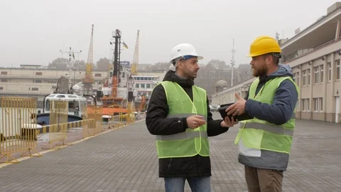 Port workers in helmets are welcomed. sea port Stock Footage 99351581