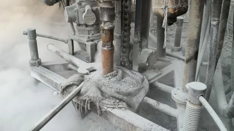 A portable borewell drilling machine operates outdoors amidst trees. Stock Footage 335773883