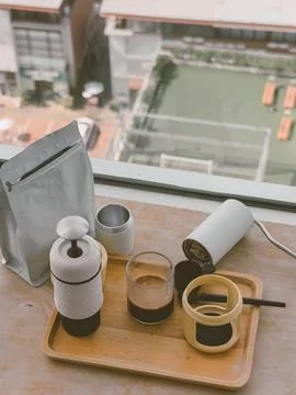 Portable coffee brewing setup with espresso maker and fresh beans on a wood.. Stock Photos