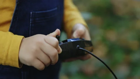 Portable control station of construction crane toy. Kid boy builder worker using Stock Footage 229734662