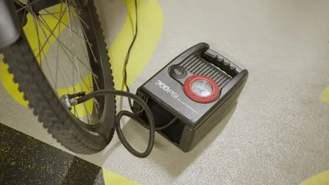 Portable Electric Air Compressor Inflating Bicycle Tire with Loud Sound Stock Footage 327648185