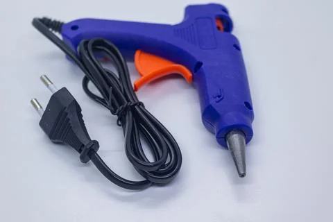Portable Electric Glue Gun for Craft and Repair Work on White Tabletop Backg Stock Photos