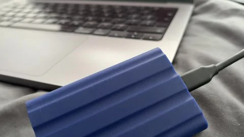 Portable External SSD Connected to Laptop With USB Cable Stock Footage 340407553