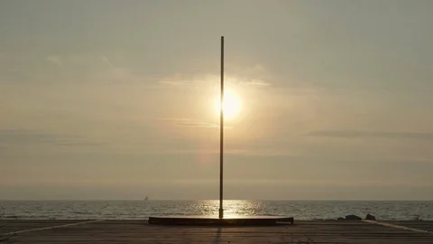 Portable fitness exercise dance spinning pole installed on the beach Stock Footage