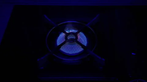 Portable Gas Burner Ignition Heating and Extinguishing Cycle in Dark Stock Footage 322774216