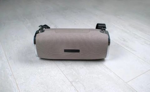 Portable grey speaker with the removable soft handle. Connect with smartphone Stock Photos