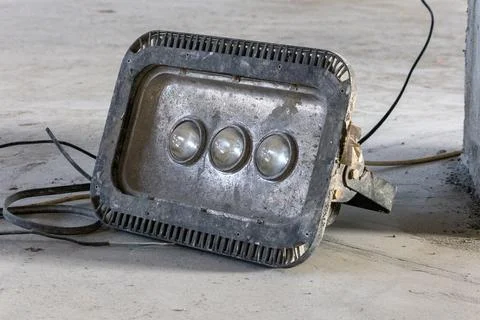 Portable handle construction light on a construction site lies on the floor Stock Photos
