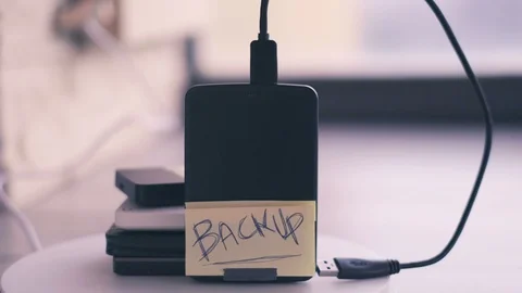 Portable hard disk backup cloud drive or physical back-up background Vídeos de archivo 125453692