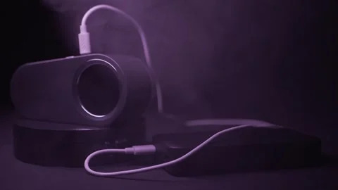 Portable Humidifier Spraying Mist Connected To Power Bank Under Purple Light Stock Footage 330112666