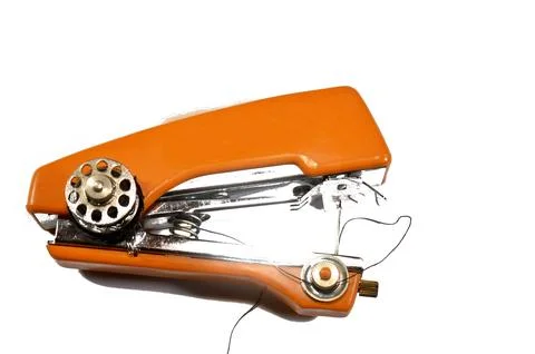 A portable, manual, handheld sewing machine, often described as stapler sty.. Stock Photos